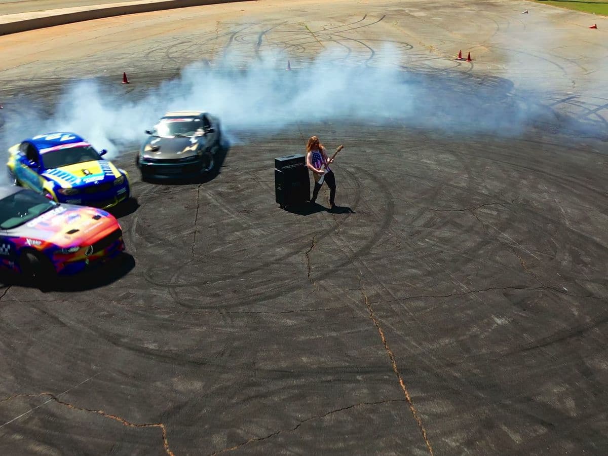 Aerial shot of drift cars sliding through their own smoke